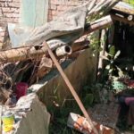 Hombre trabajando sobre una casa en ruinas