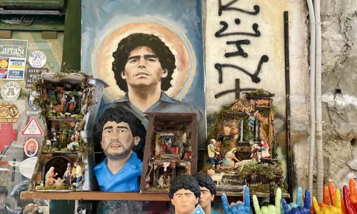 Rostros de Maradona junto a pesebres en un comercio de Nápoles. Abril de 2023.  /